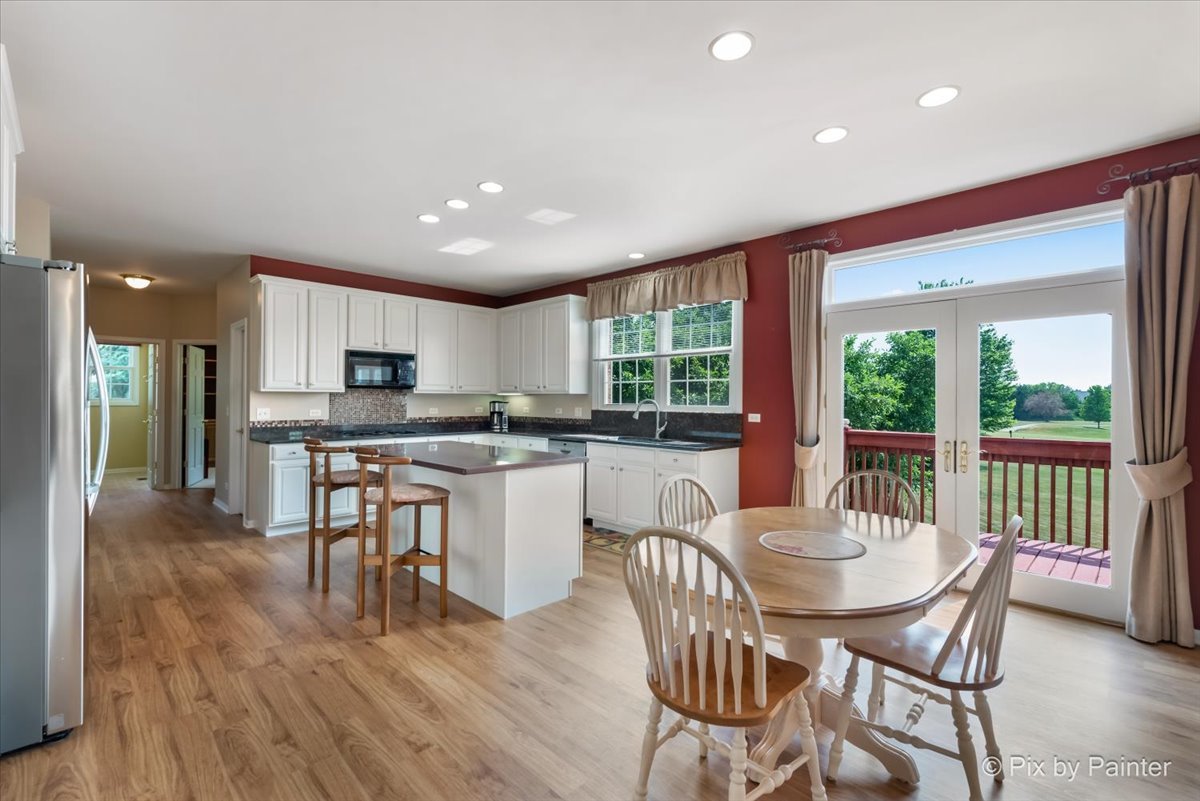8475 Watson Circle Lakewood, IL 60014 - Photo 10 of 49 a view of a dining room with furniture window and wooden floor