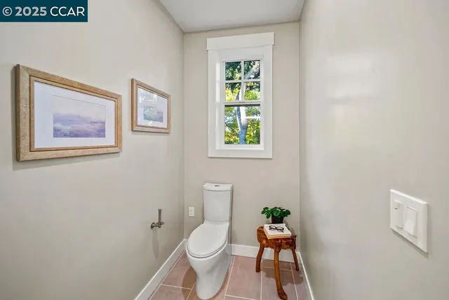a white toilet sitting next to a window
