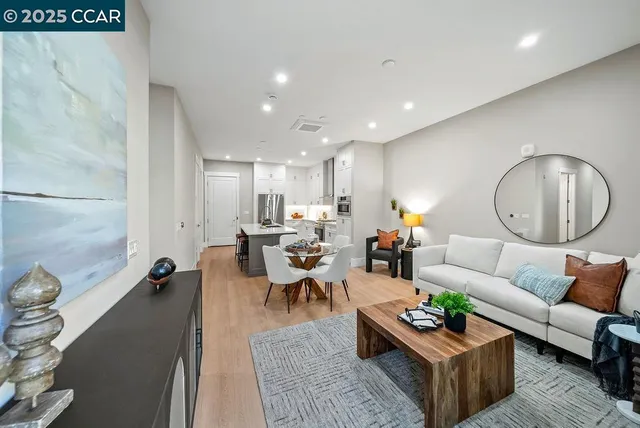 a living room with furniture a rug and a large mirror