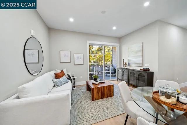 a living room with furniture and a floor to ceiling window