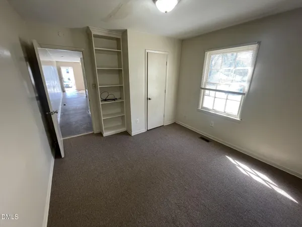en empty room with windows and closet