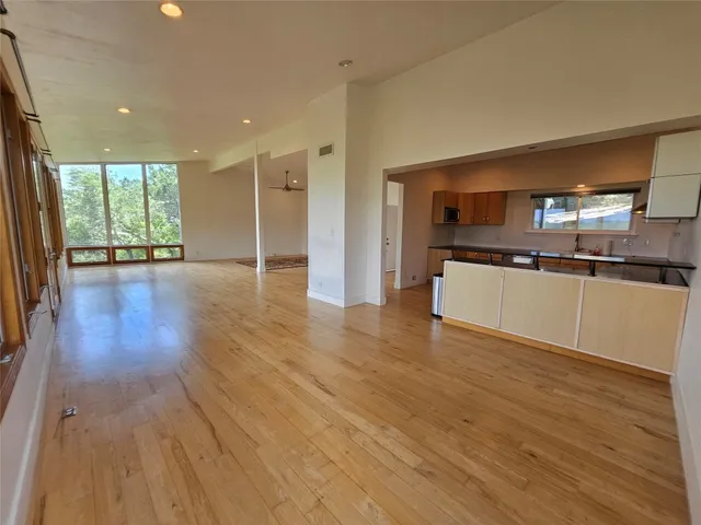 a view of a kitchen with a sink and microwave