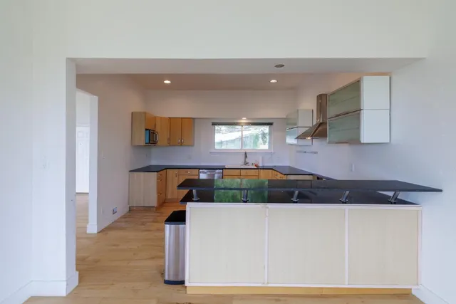 a kitchen with a sink a cabinets and window