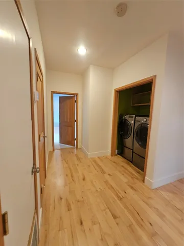 a view of empty room with wooden floor