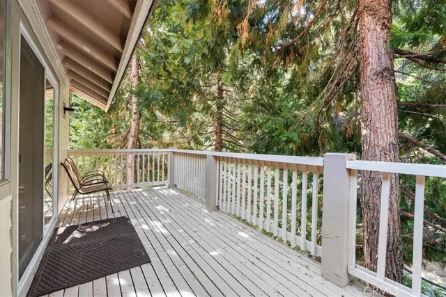 a view of a two chairs with wooden floor and fence
