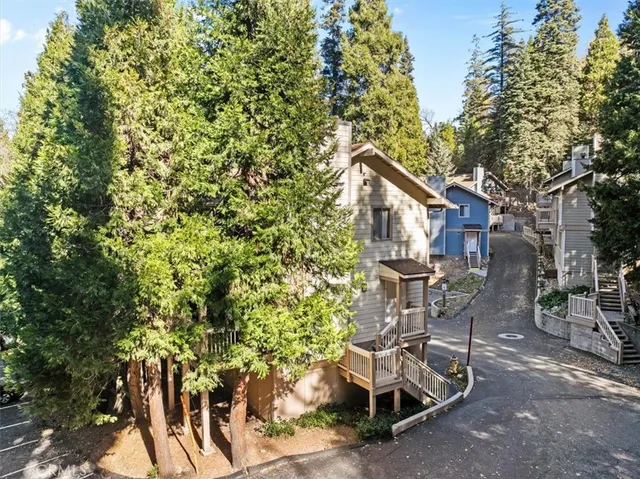 an aerial view of a house with a mountain
