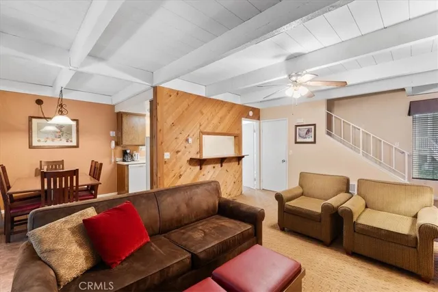 a living room with furniture a couch and a chandelier