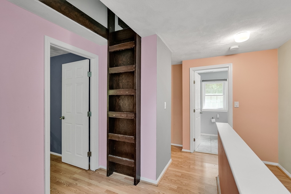 58 MacIntosh Lane, Unit 58 Boxborough, MA 01719 - Photo 19 of 23 a view of a hallway with wooden floor and closet