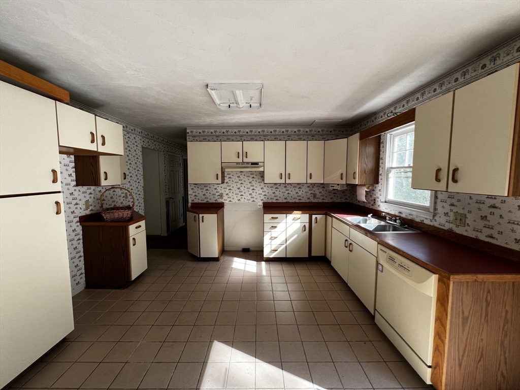 78 Redemption Rock Trail North Princeton, MA 01541 - Photo 19 of 39 a large kitchen with a stove top oven cabinets a sink dishwasher and a refrigerator