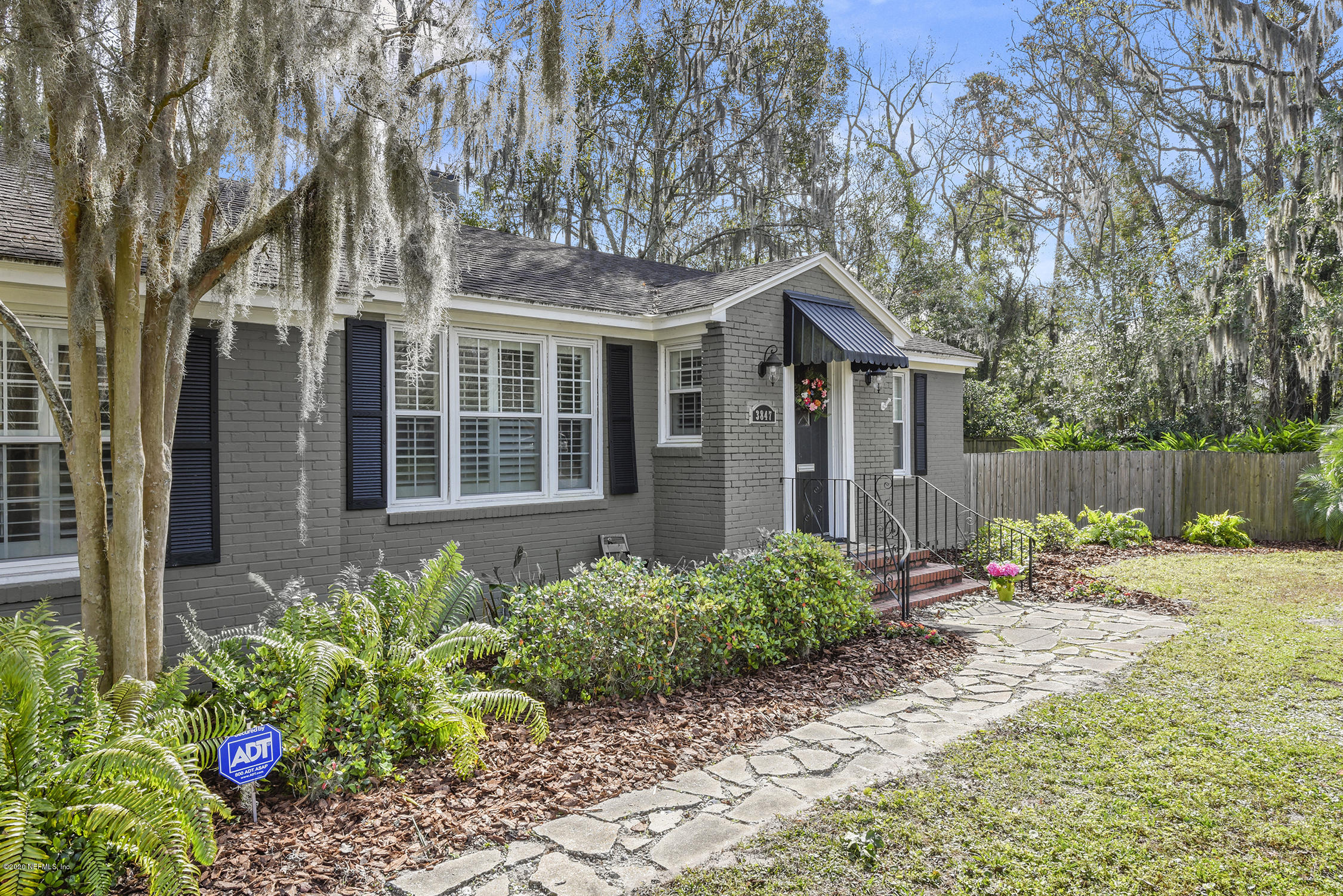3847 Gadsden Road Jacksonville, FL 32207 - Photo 2 of 29 a wooden bench sitting in front of a house