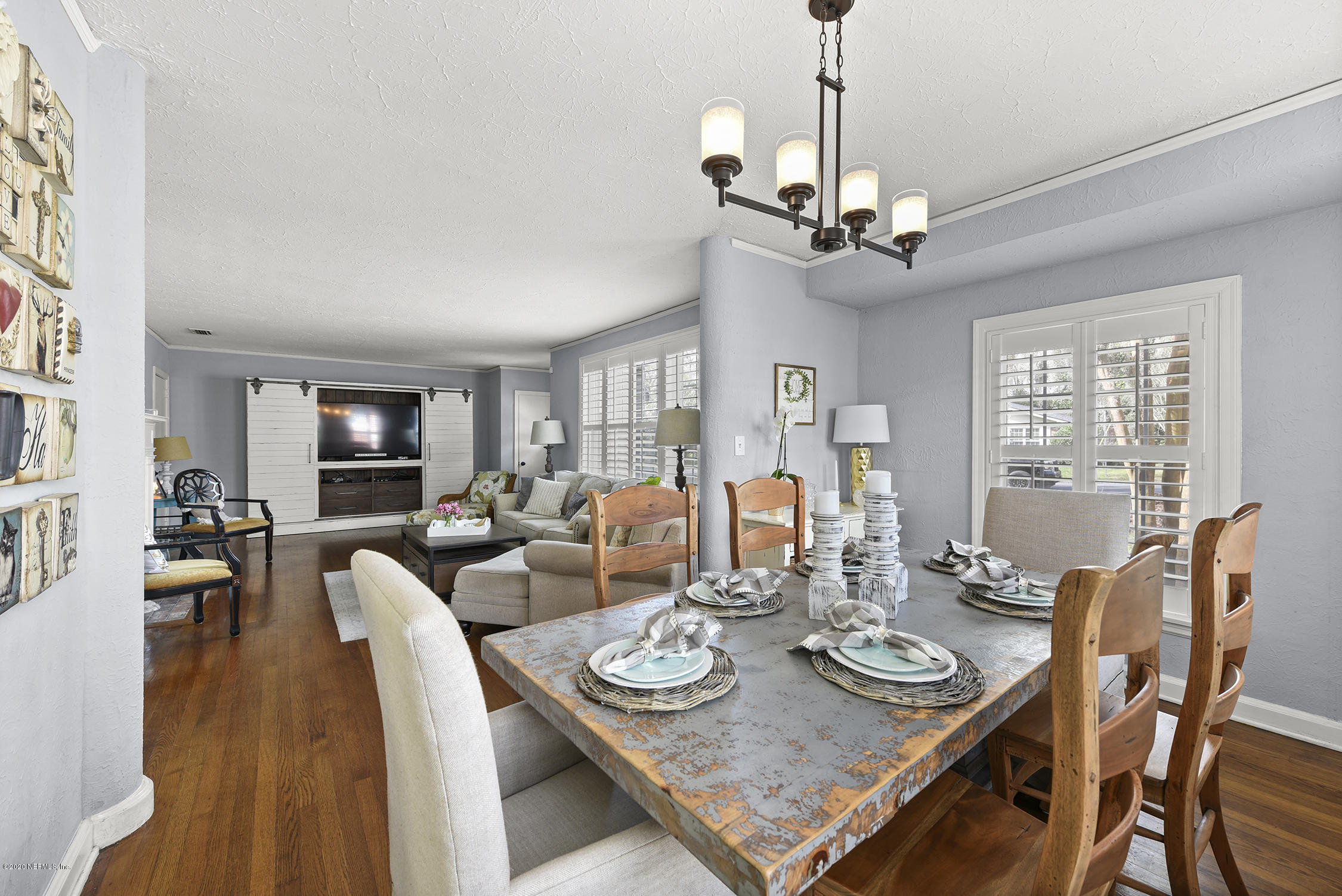 3847 Gadsden Road Jacksonville, FL 32207 - Photo 9 of 29 a view of a dining room with furniture a chandelier and wooden floor
