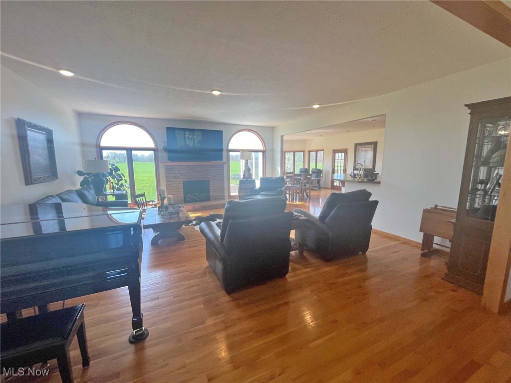 2159 Alliance Road Deerfield, OH 44411 - Photo 12 of 33 Living area featuring recessed lighting, wood finished floors, a brick fireplace, and plenty of natural light