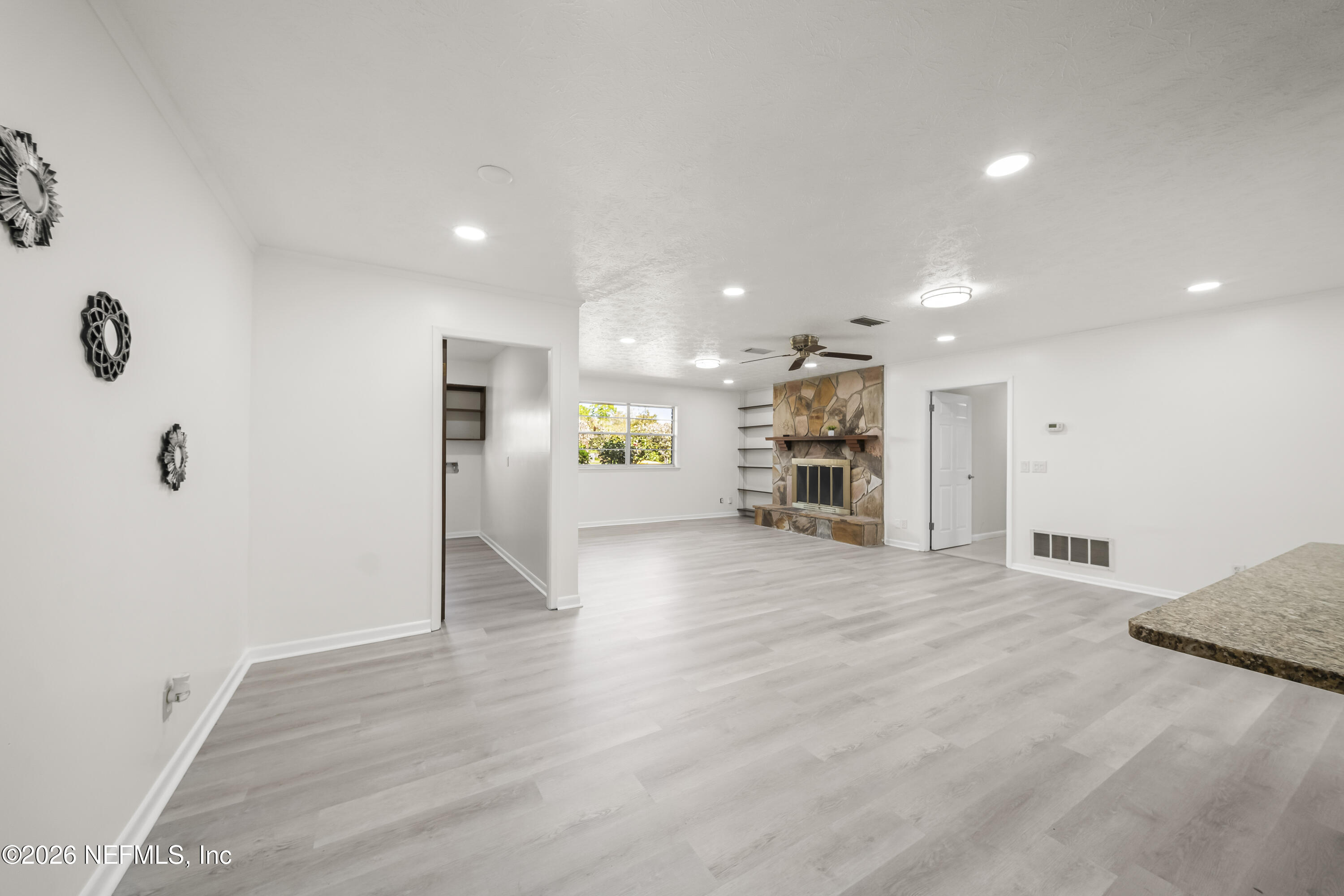 3571 Sandburg Road Jacksonville, FL 32277 - Photo 11 of 41 a view of an empty room and a kitchen