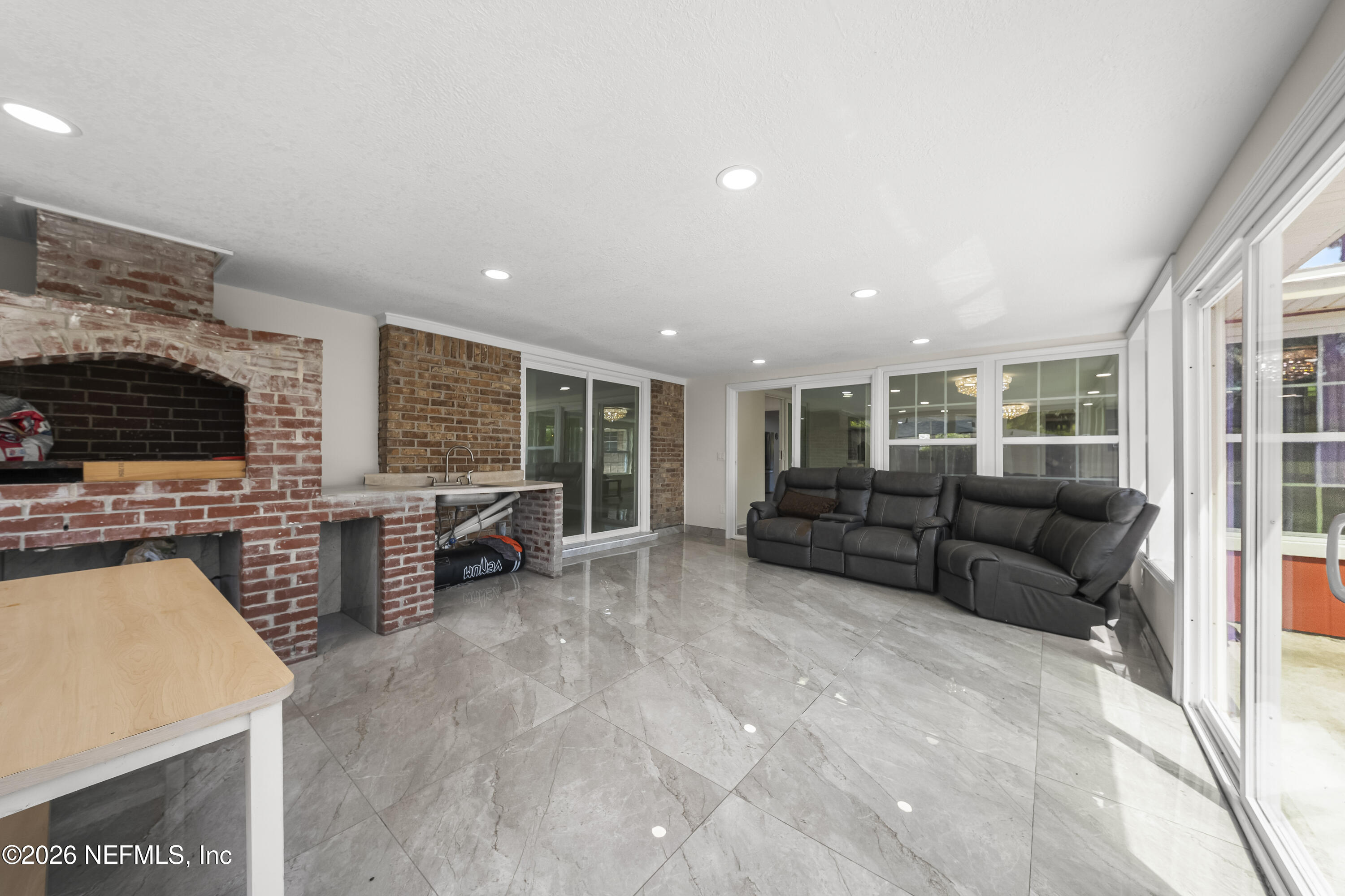 3571 Sandburg Road Jacksonville, FL 32277 - Photo 14 of 41 a living room with furniture and a flat screen tv
