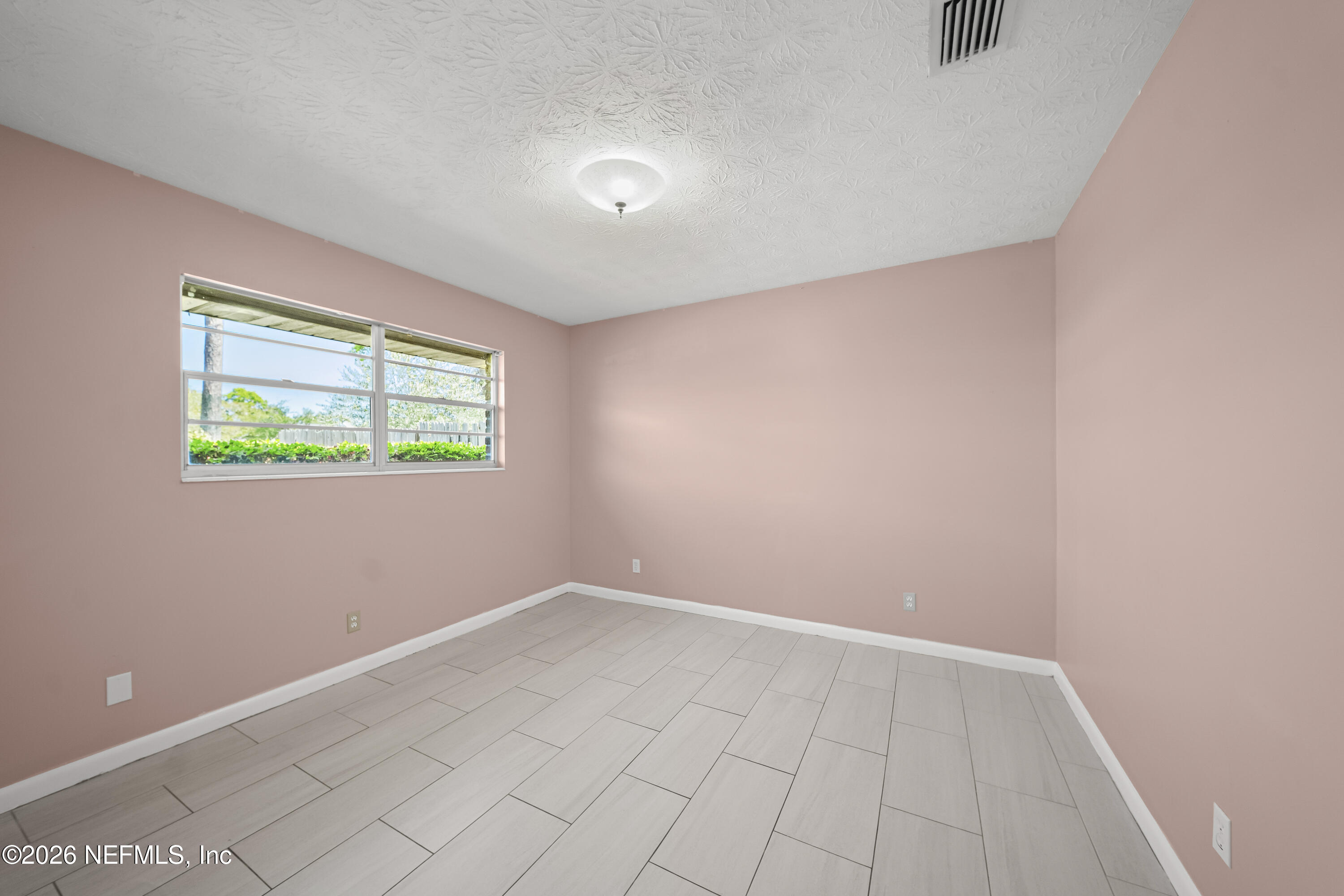 3571 Sandburg Road Jacksonville, FL 32277 - Photo 16 of 41 an empty room with windows