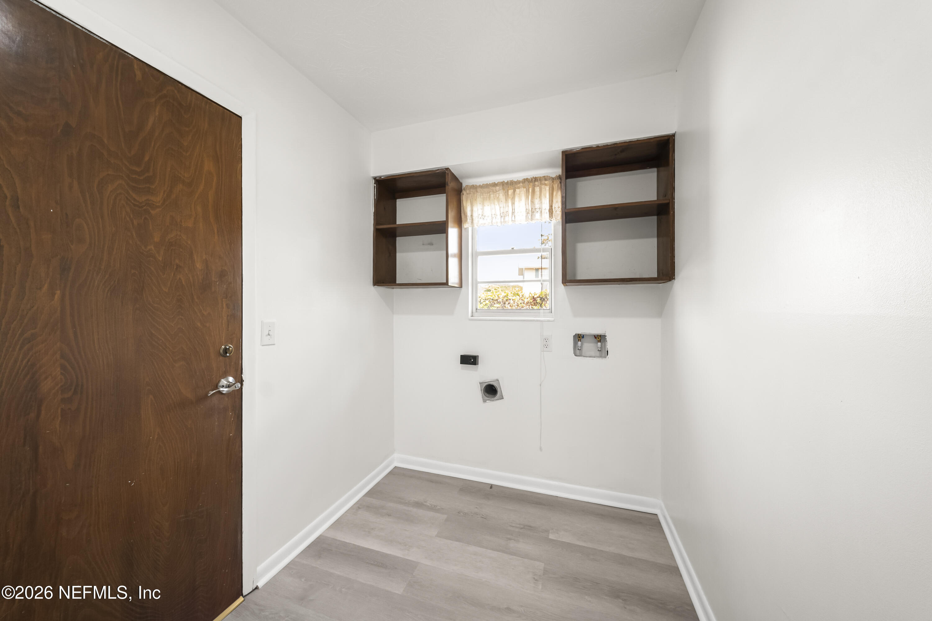 3571 Sandburg Road Jacksonville, FL 32277 - Photo 17 of 41 a view of a hallway with wooden floor and closet