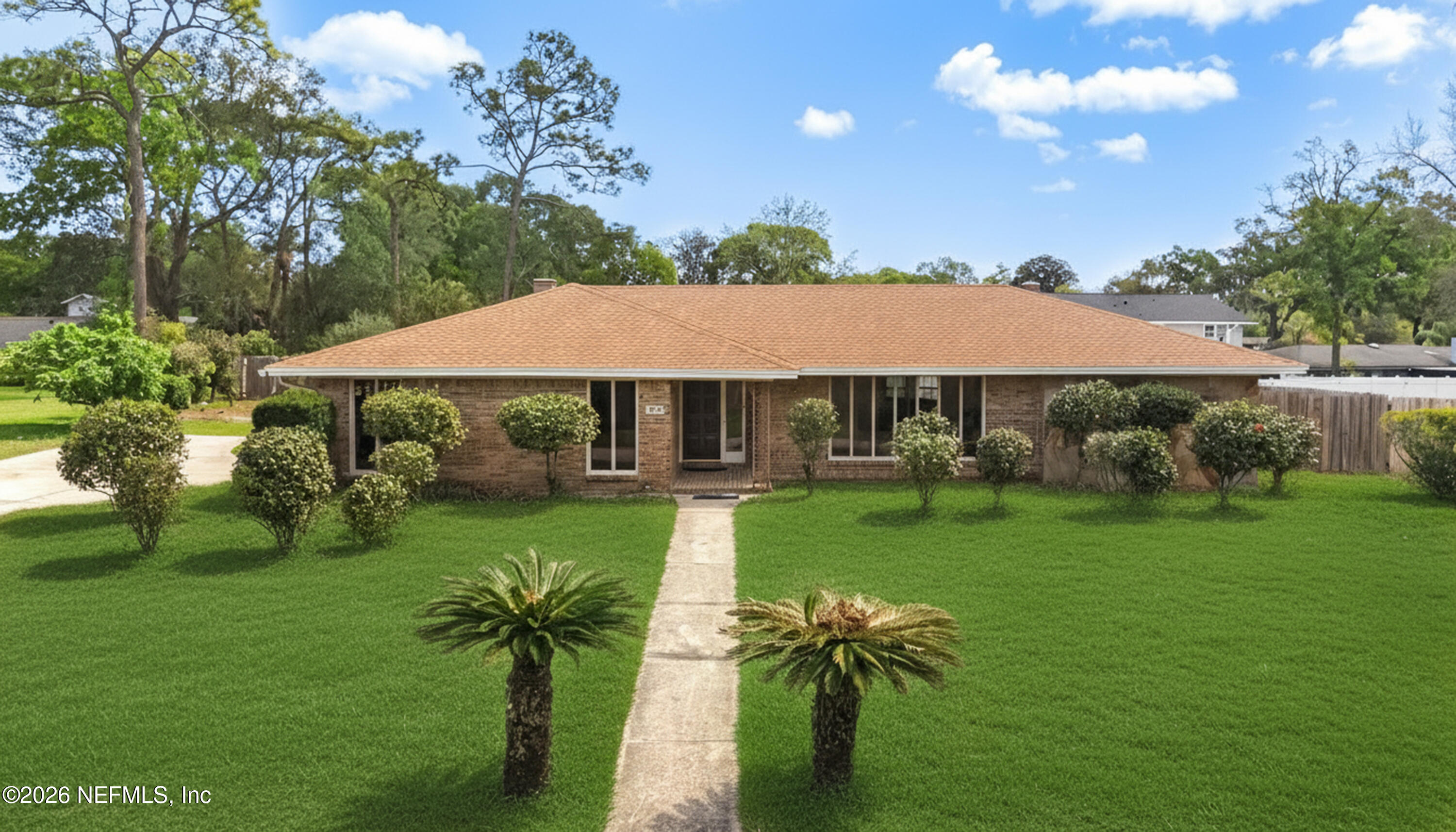 3571 Sandburg Road Jacksonville, FL 32277 - Photo 2 of 41 a view of house with garden space and trees