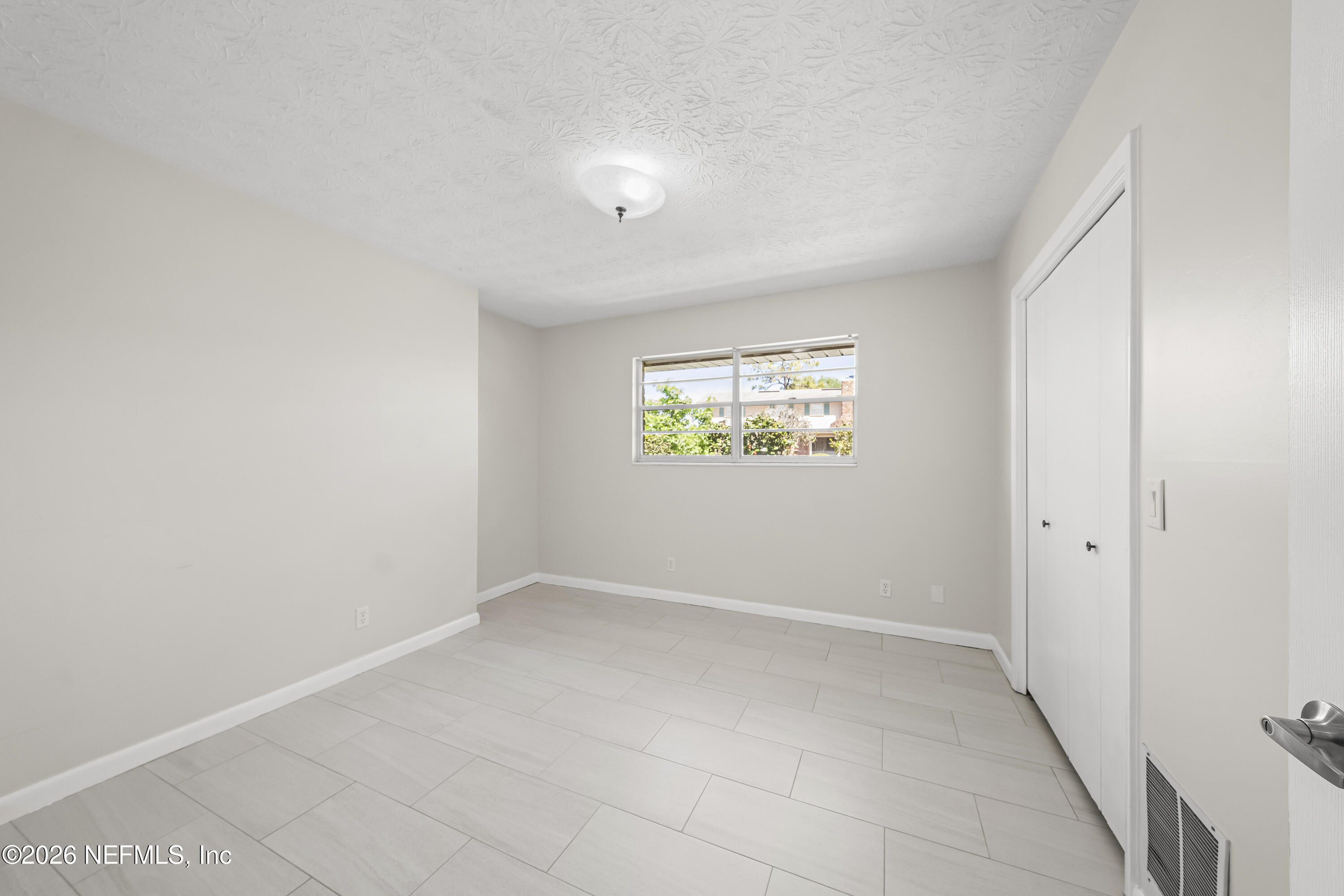 3571 Sandburg Road Jacksonville, FL 32277 - Photo 27 of 41 an empty room with windows