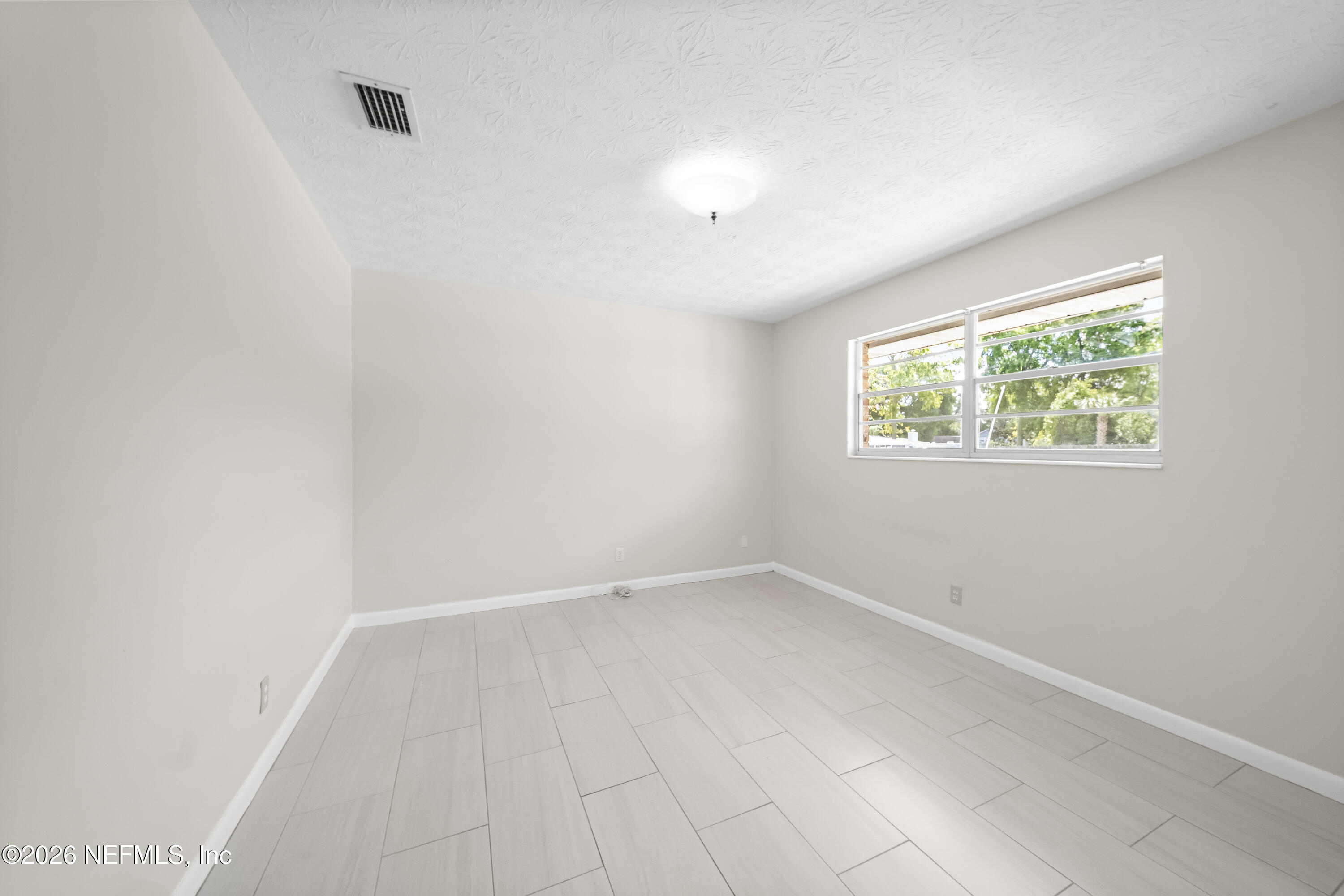 3571 Sandburg Road Jacksonville, FL 32277 - Photo 28 of 41 an empty room with windows