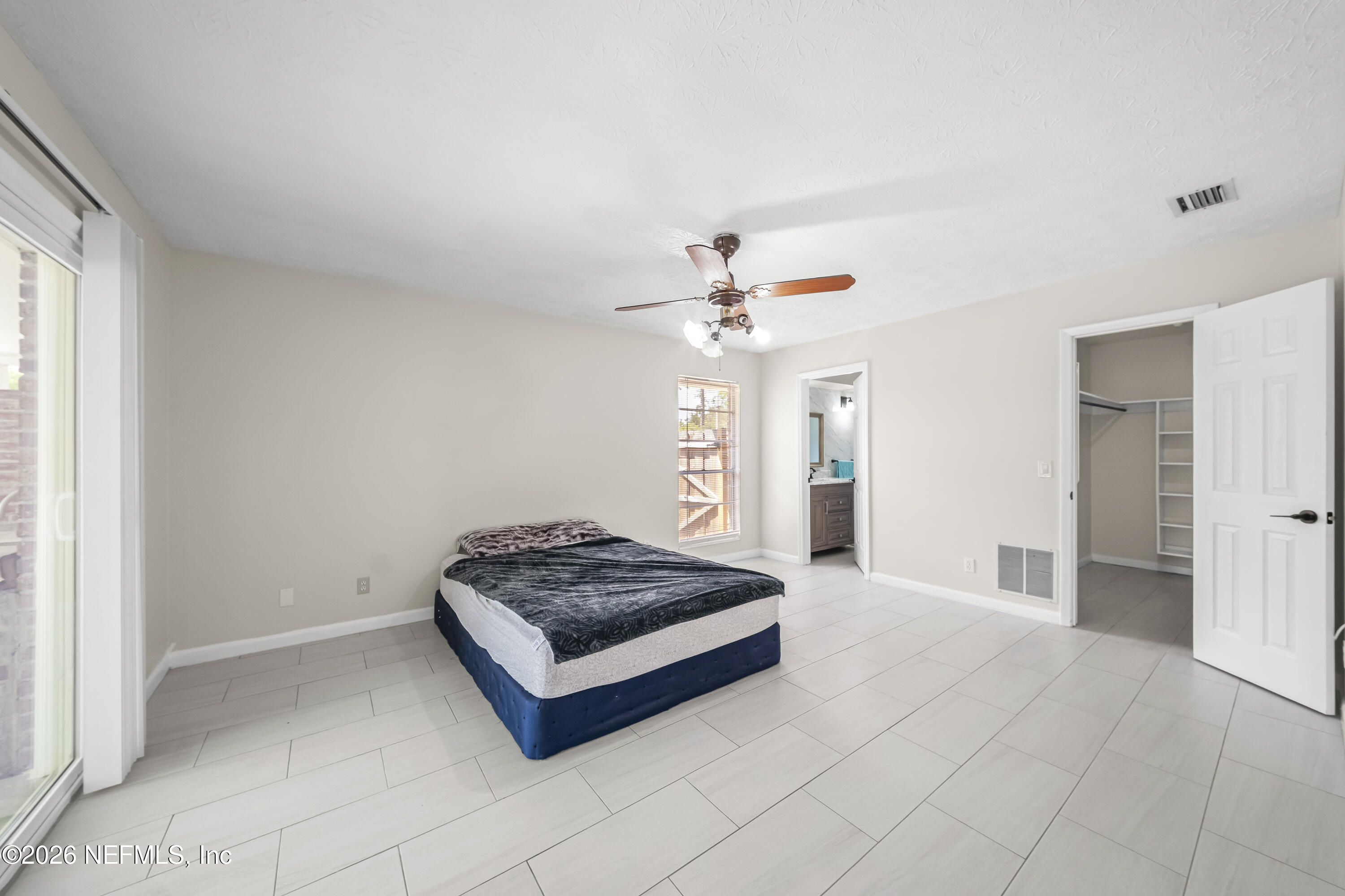 3571 Sandburg Road Jacksonville, FL 32277 - Photo 30 of 41 a living room with furniture and a chandelier