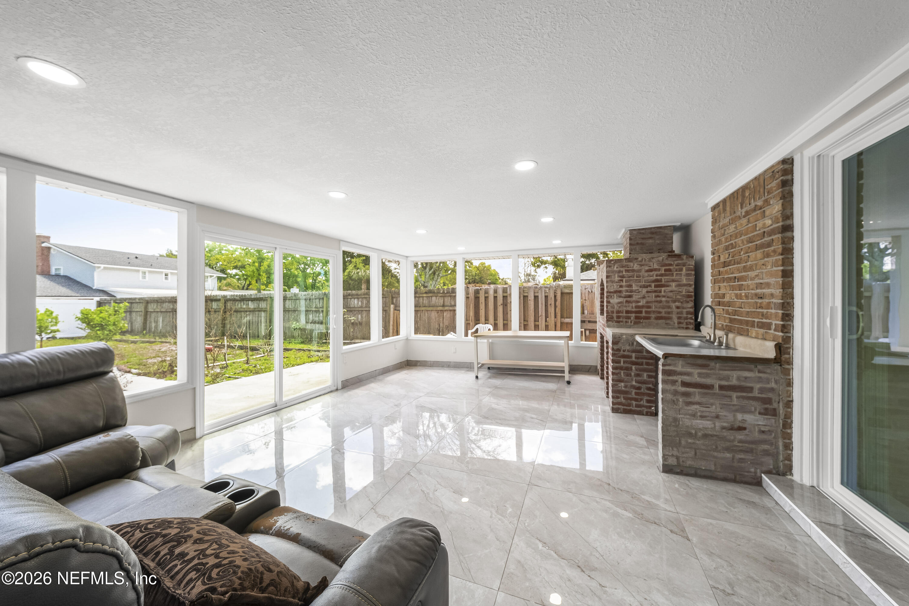 3571 Sandburg Road Jacksonville, FL 32277 - Photo 39 of 41 a living room with furniture and large windows