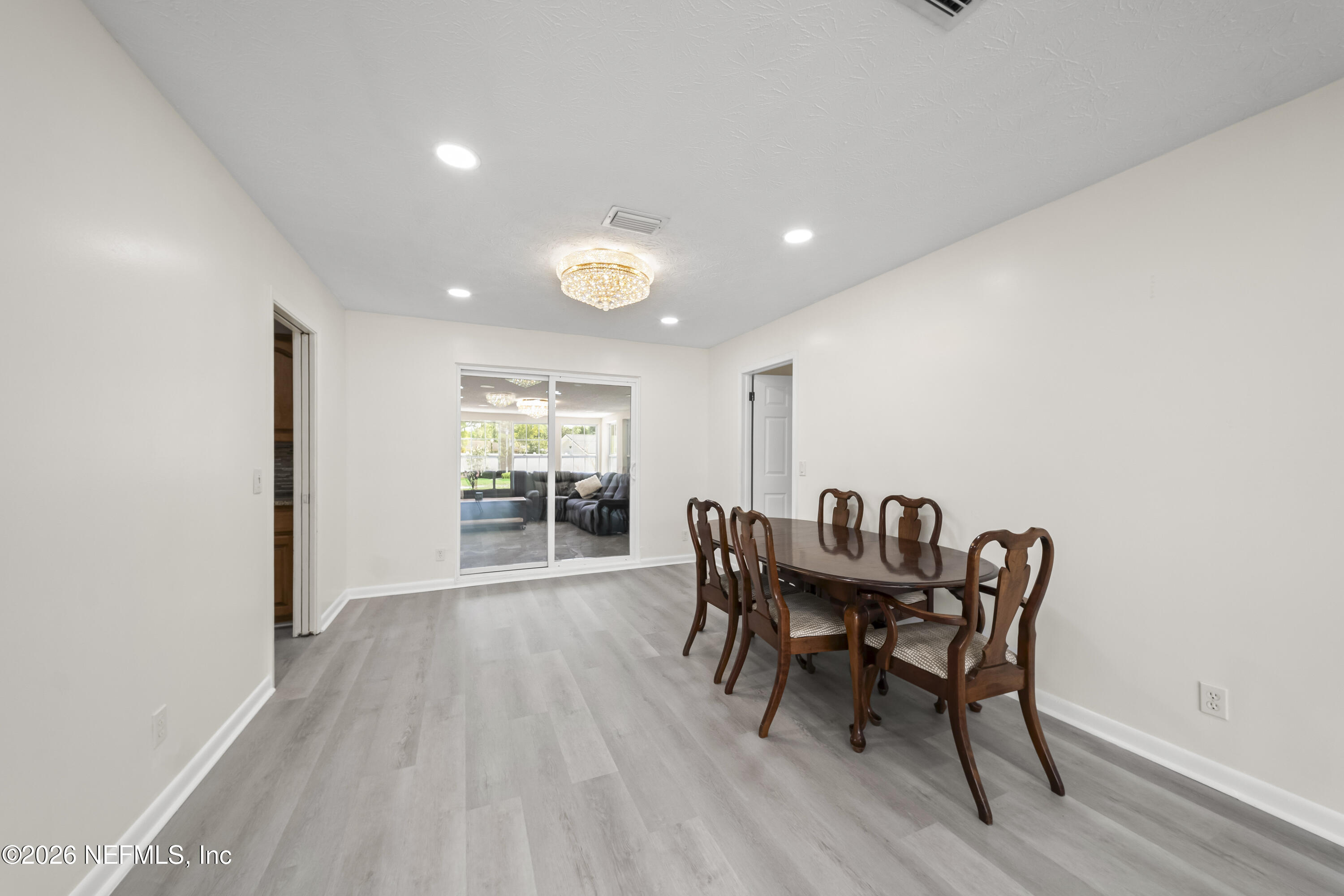 3571 Sandburg Road Jacksonville, FL 32277 - Photo 10 of 41 a view of a dining room with furniture and wooden floor