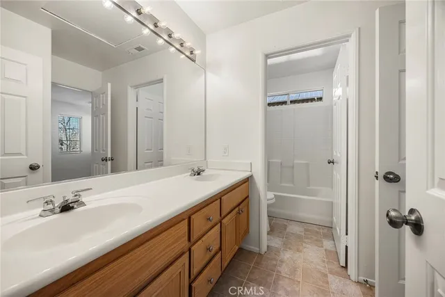 a bathroom with a tub sink and mirror