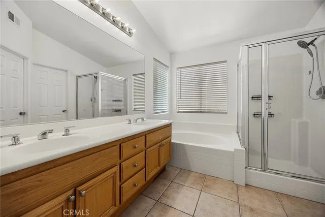 a spacious bathroom with a tub sink shower and mirror