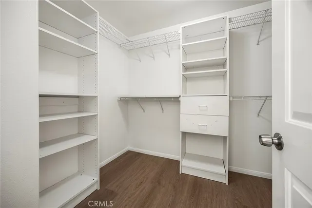 a view of walk in closet with empty racks