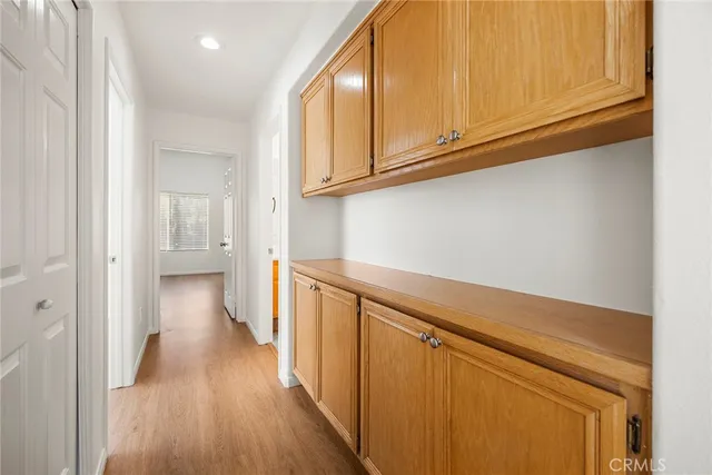 a view of a hallway with wooden floor
