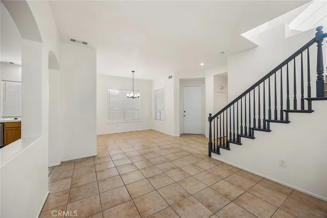 a view of a hallway with a door and stairs