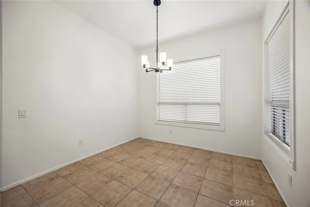 a view of a room with window and chandelier fan