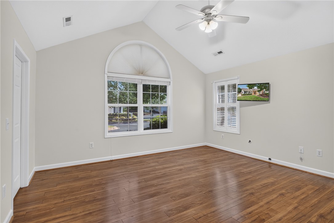 134 Life Style Lane Anderson, SC 29621 - Photo 13 of 44 Vaulted ceilings elevate this well-lit bedroom featuring rich hardwood flooring and charming window shutters.