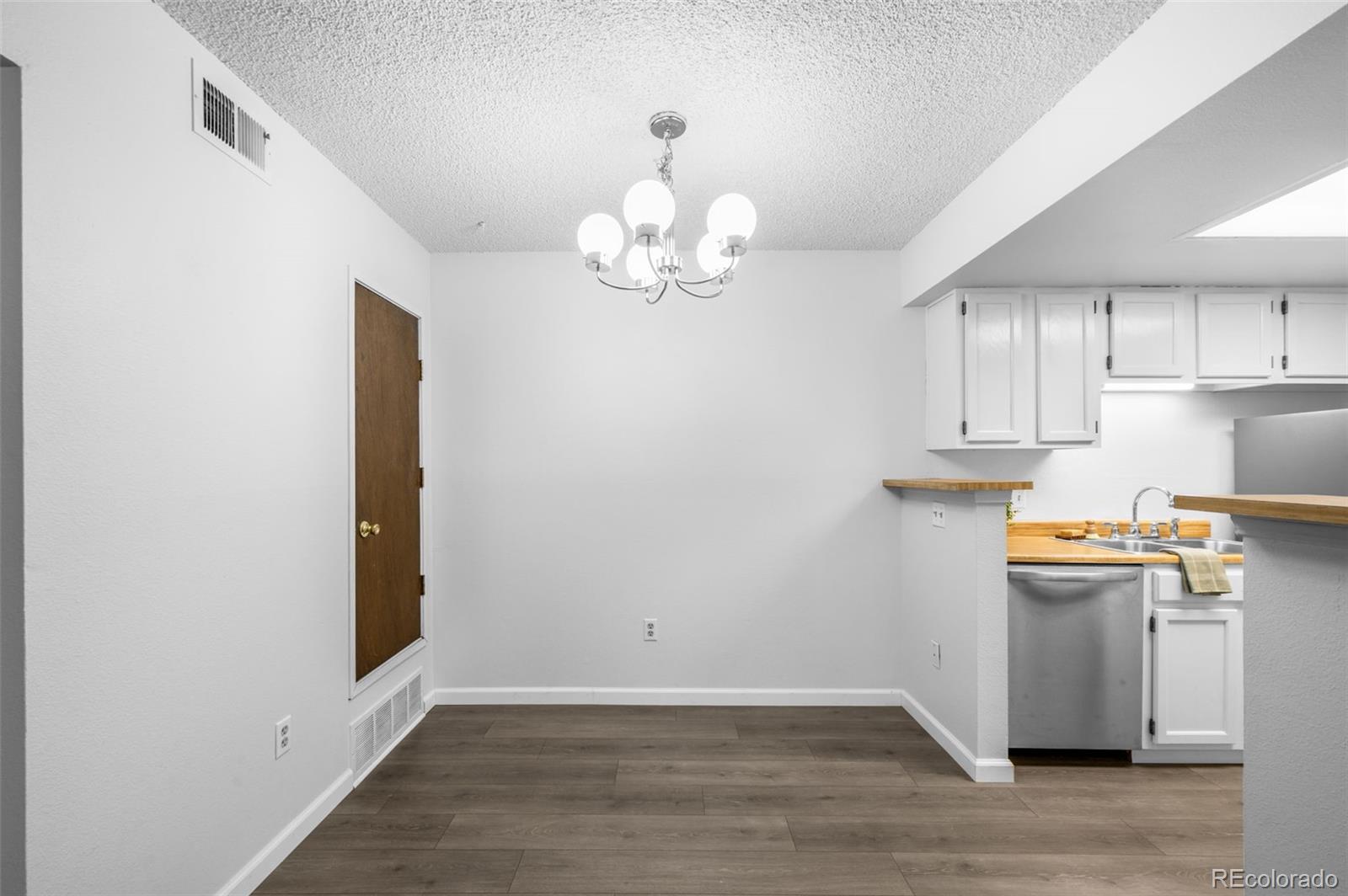 4400 South Quebec Street, Unit 102V Denver, CO 80237 - Photo 11 of 21 a view of a kitchen with wooden floor and a window