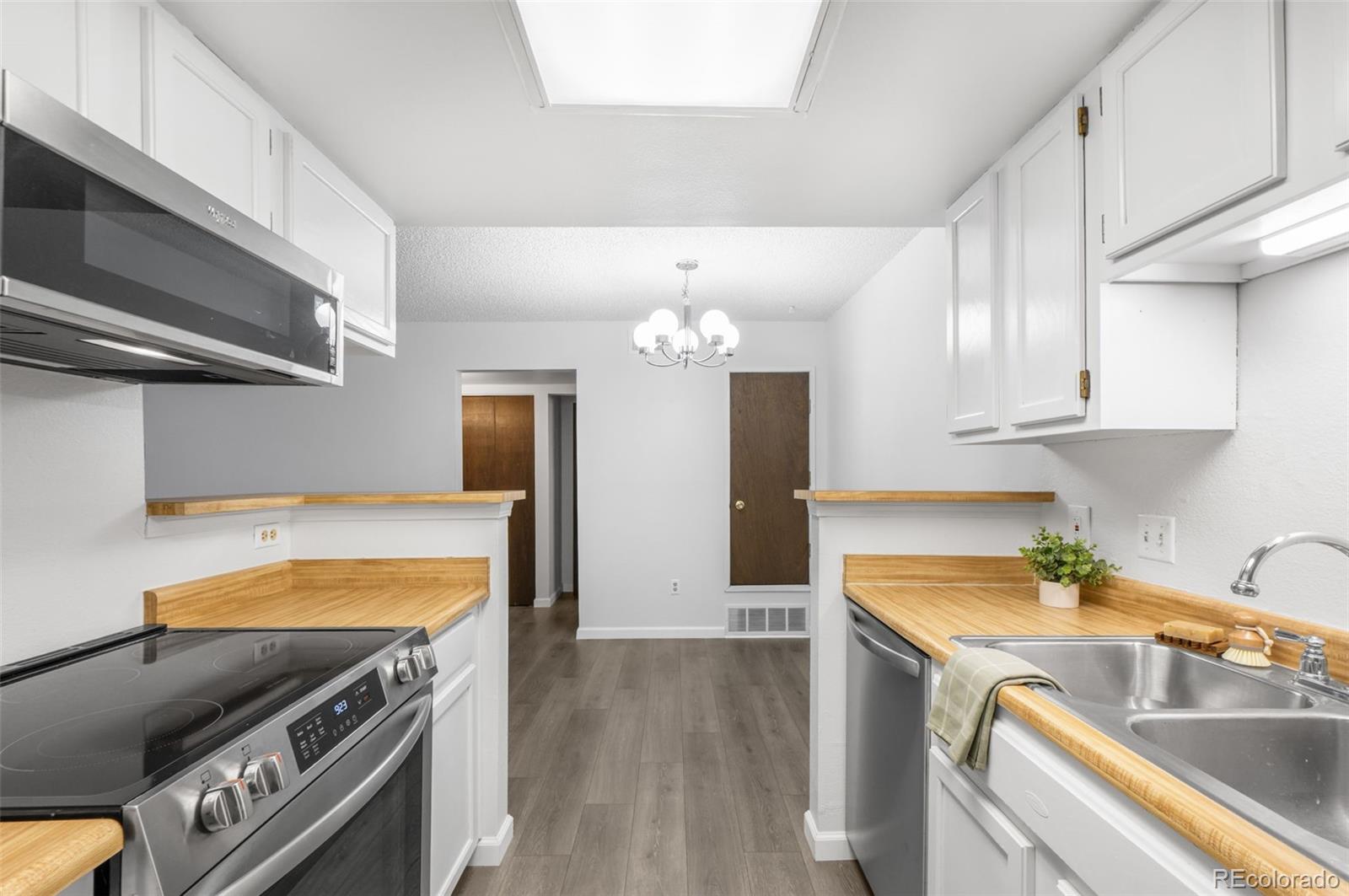 4400 South Quebec Street, Unit 102V Denver, CO 80237 - Photo 13 of 21 a kitchen that has a sink and a stove