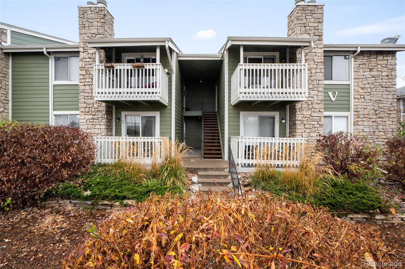 4400 South Quebec Street, Unit 102V Denver, CO 80237 - Photo 2 of 21 a front view of a house with a yard