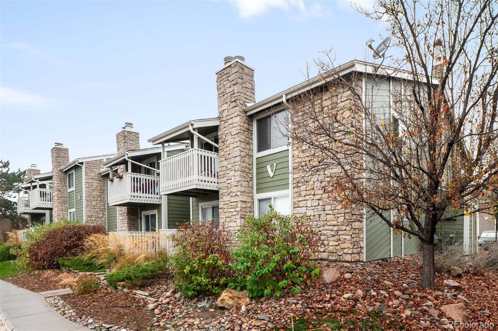 4400 South Quebec Street, Unit 102V Denver, CO 80237 - Photo 3 of 21 a front view of a house with a yard