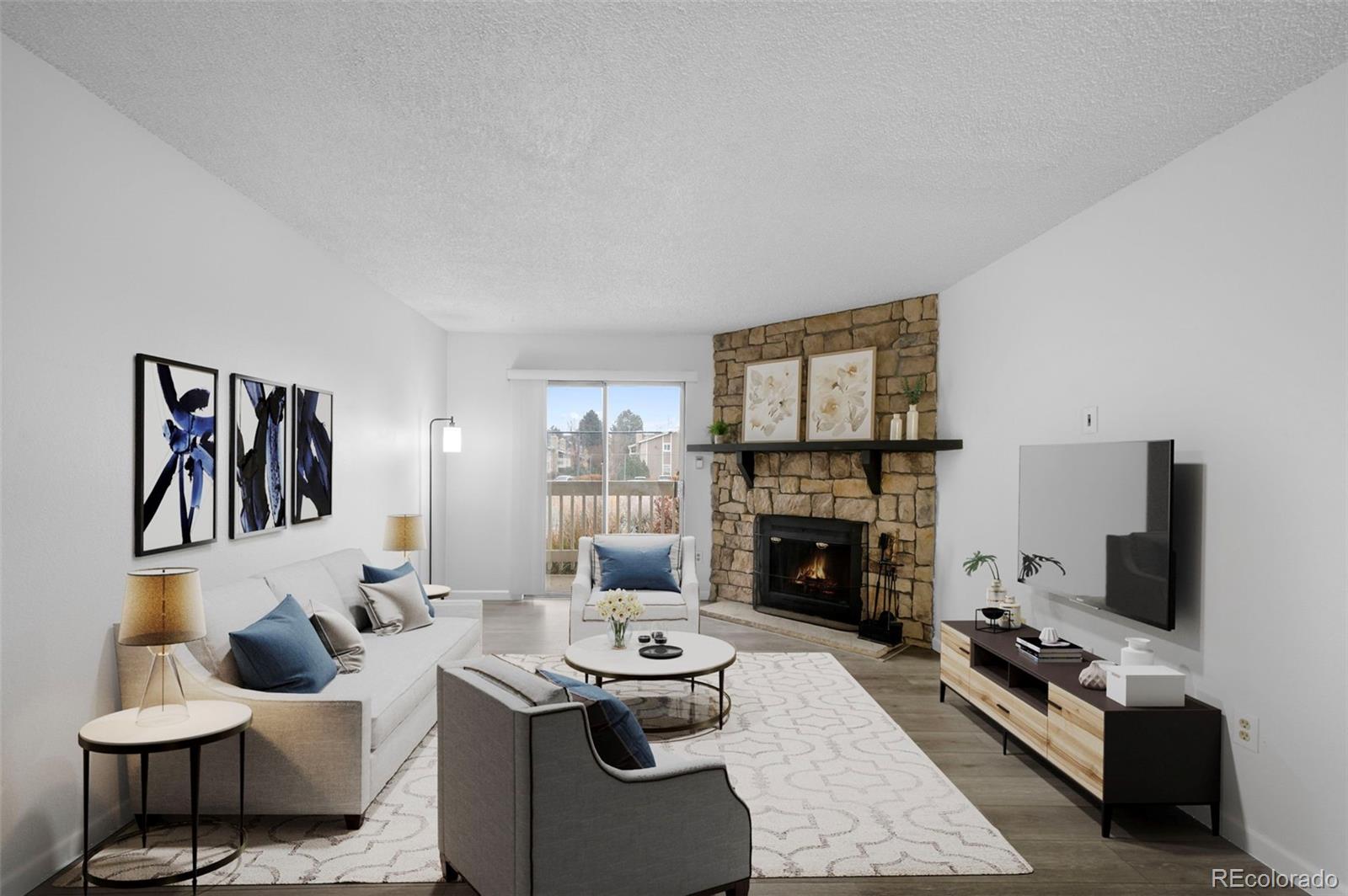 4400 South Quebec Street, Unit 102V Denver, CO 80237 - Photo 4 of 21 a living room with furniture and a fireplace