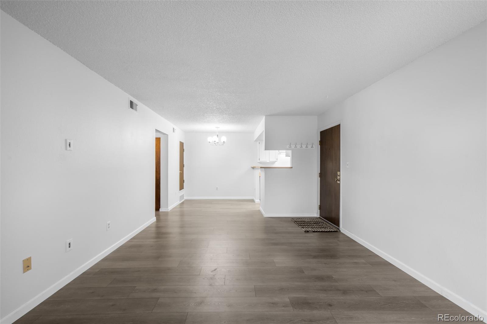 4400 South Quebec Street, Unit 102V Denver, CO 80237 - Photo 8 of 21 a view of empty room with wooden floor