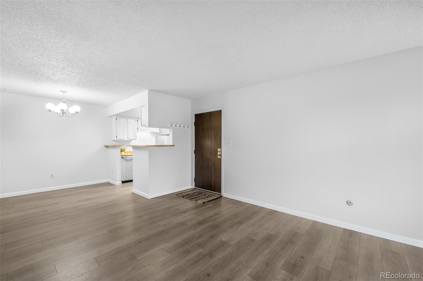 4400 South Quebec Street, Unit 102V Denver, CO 80237 - Photo 9 of 21 a view of a kitchen with a refrigerator and a sink
