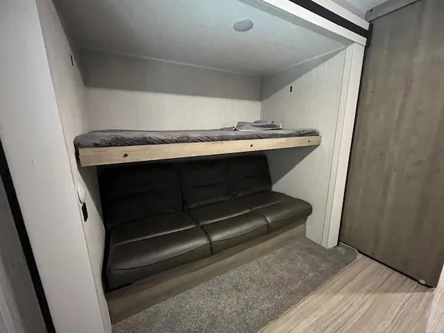 a bedroom with a bed and a mirror