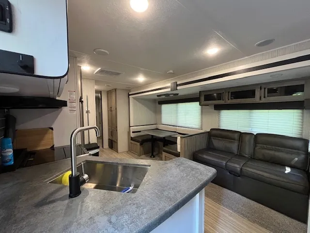 a kitchen with stainless steel appliances kitchen island granite countertop a refrigerator and a stove top oven