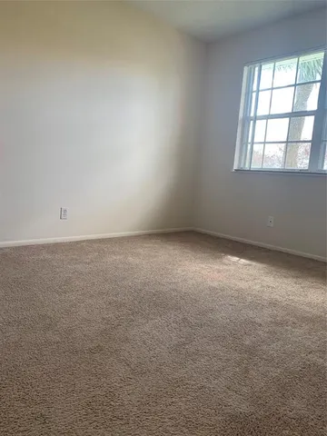 an empty room with a windows