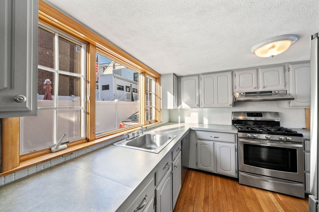 86-88 Pearl Street Boston, MA 02129 - Photo 11 of 30 a kitchen that has a sink and a stove