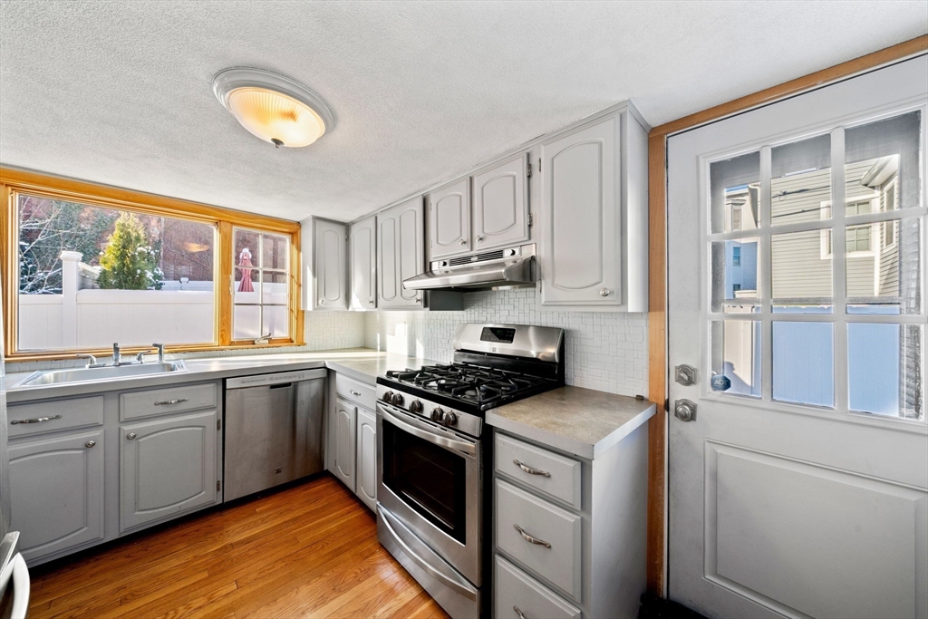 86-88 Pearl Street Boston, MA 02129 - Photo 12 of 30 a kitchen with stainless steel appliances granite countertop a stove and a sink