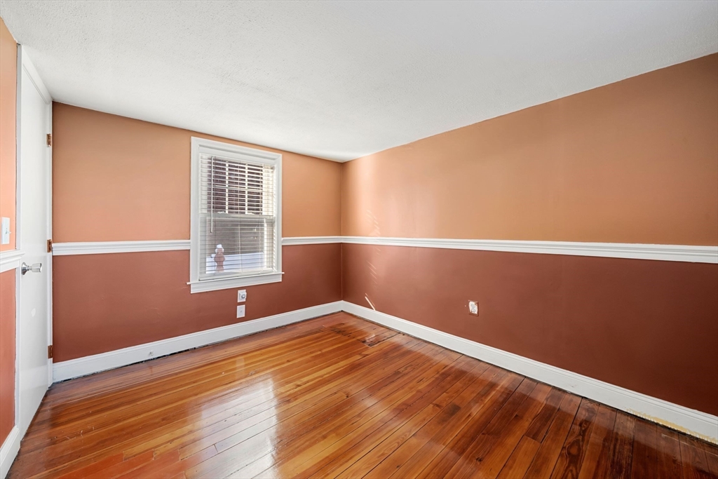 86-88 Pearl Street Boston, MA 02129 - Photo 17 of 30 an empty room with wooden floor and windows