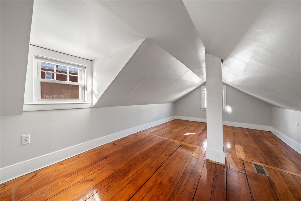 86-88 Pearl Street Boston, MA 02129 - Photo 18 of 30 a view of an empty room with wooden floor and a window