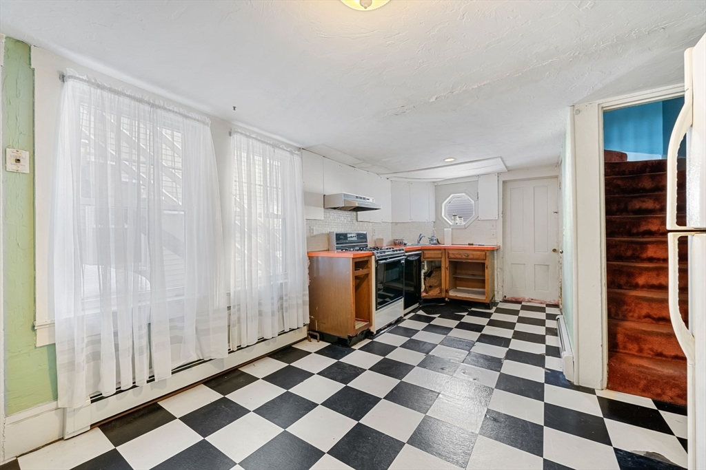 86-88 Pearl Street Boston, MA 02129 - Photo 24 of 30 a kitchen with a checkered floor and white cabinets