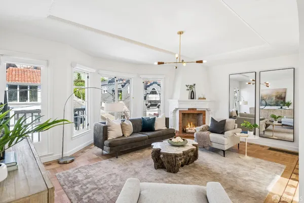 a living room with furniture fireplace and a chandelier