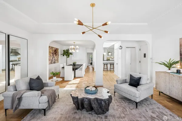 a living room with furniture and a ceiling fan